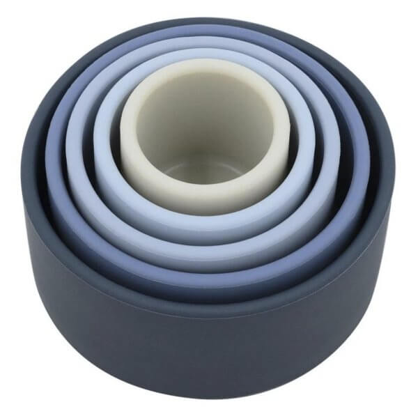 Blue collapsible silicone nesting bowls stacked together into a compact form (set of nested rings).