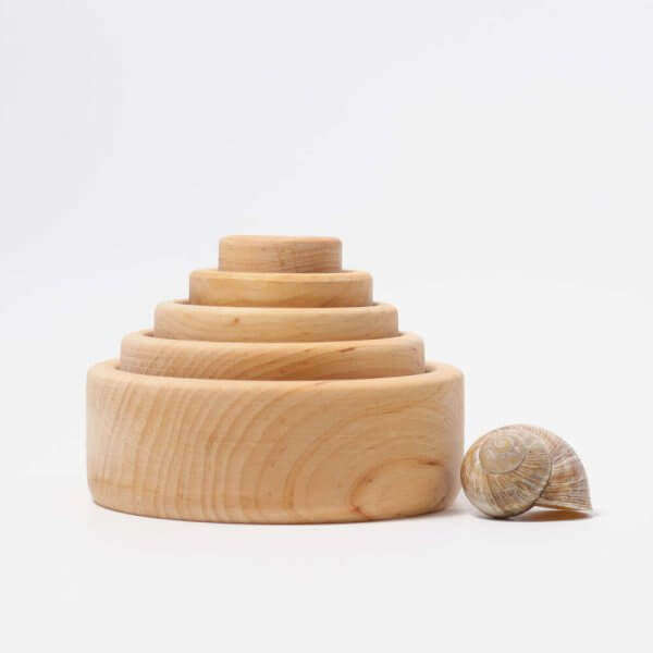 Wooden stacking toy with four rounded rings stacked into a tower on a white background and visible wood grain. | Bambino Eco Toys Wooden stacking toy with four rounded rings stacked into a tower on a white background and visible wood grain.