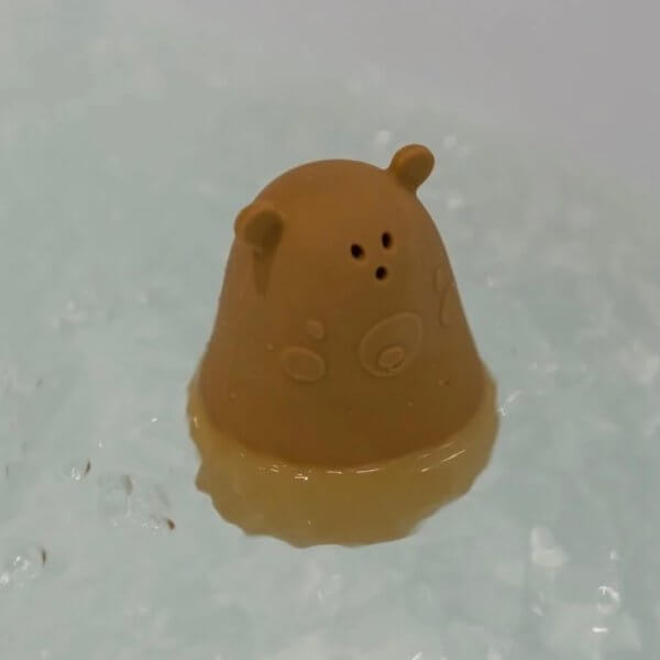 Nuuroo set of two bath toys | Bambino Eco Toys Brown bear-shaped bath toy floating in bubbly water