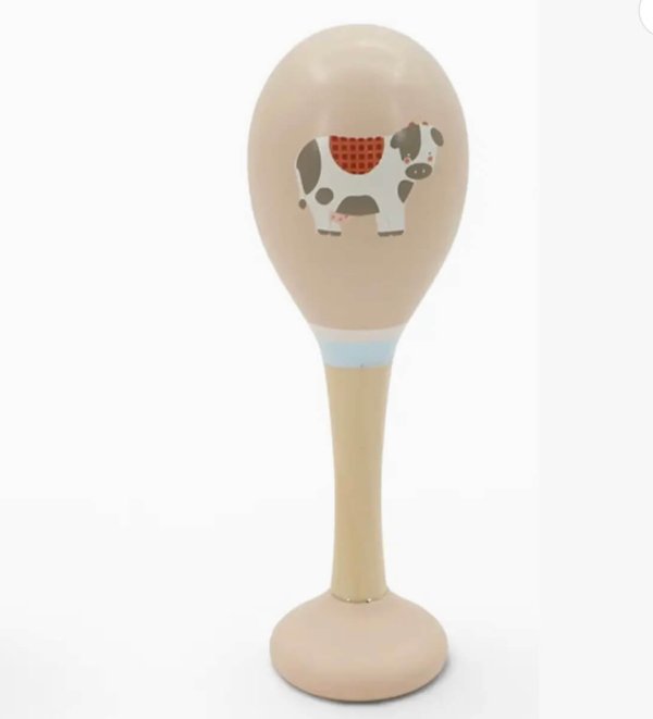 Beige standing display item with a large oval top featuring a cartoon cow, mounted on a rounded base.