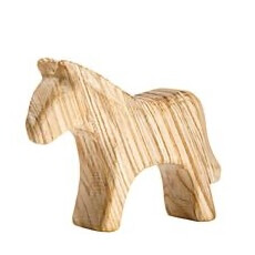 Wooden horse toy carved from light-colored wood with visible grain